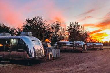 a group of airstream trailers in the desert