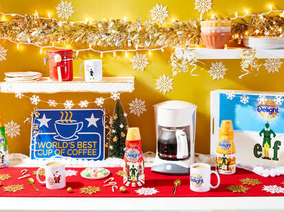 Holiday decorations surround a coffee maker. 