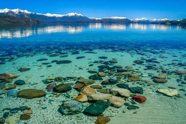 shallow waters of bariloche lake surrounded by mountains