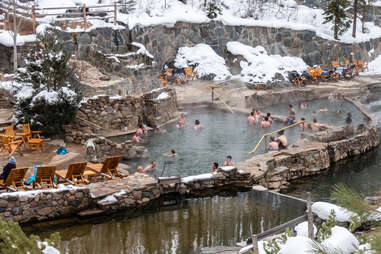 people soaking in hot springs on a winter day