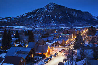 an enormous mountain towering over a tiny town