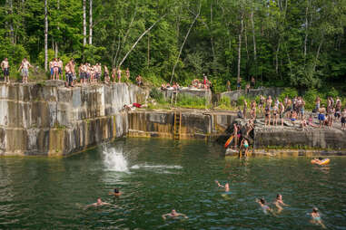 people swimming in a reservoir in a quarry