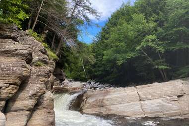 a waterfall cascading into a swimming hole