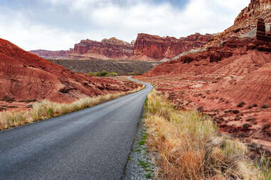 a road leading through red rock mountains