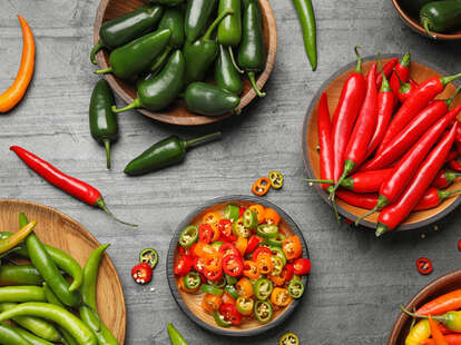 ripe hot chili peppers on grey table
