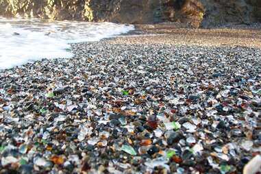 Close-up view of the colored glass beads mixed in the sand at Glass Beach near Fort Bragg, CA