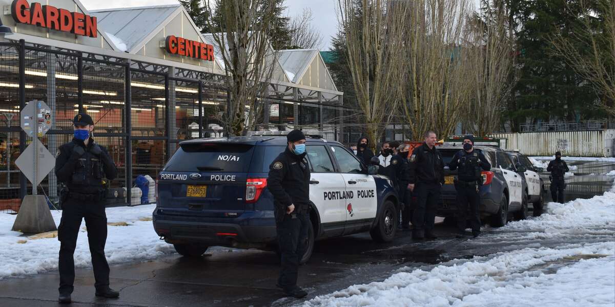 Portland police prevent people from taking food discarded from the grocery store trash after a winter storm