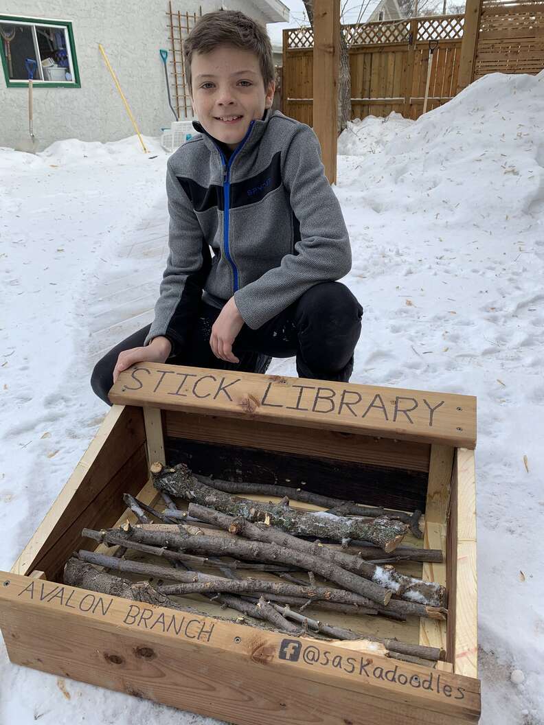 Jeremiah poses with stick library he built