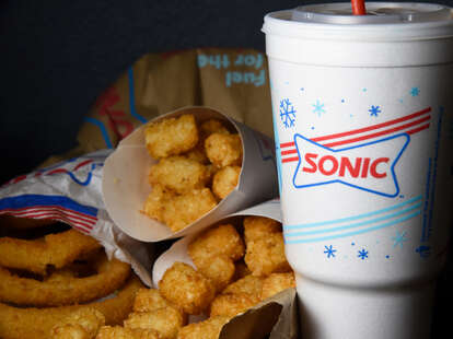 Sonic onion rings, tater tots, and a soda cup. 