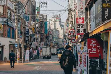 street with billboards and pedestrians in seoul, south korea