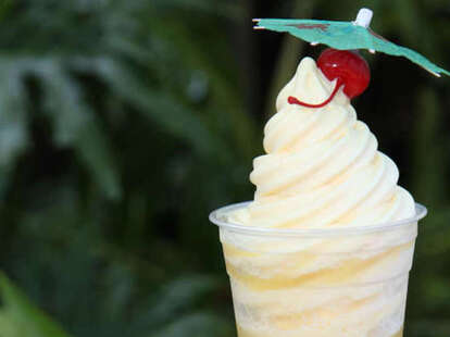 Disney's Dole Whip with a cherry on top and a paper umbrella.