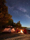 friends around a campfire on a lake