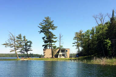 wooden frame house by a lake