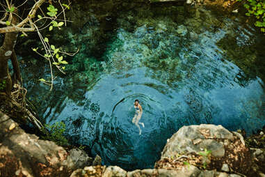 woman swimming in cenote