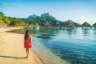 woman walking on the beach in Bora Bora, French Polynesia