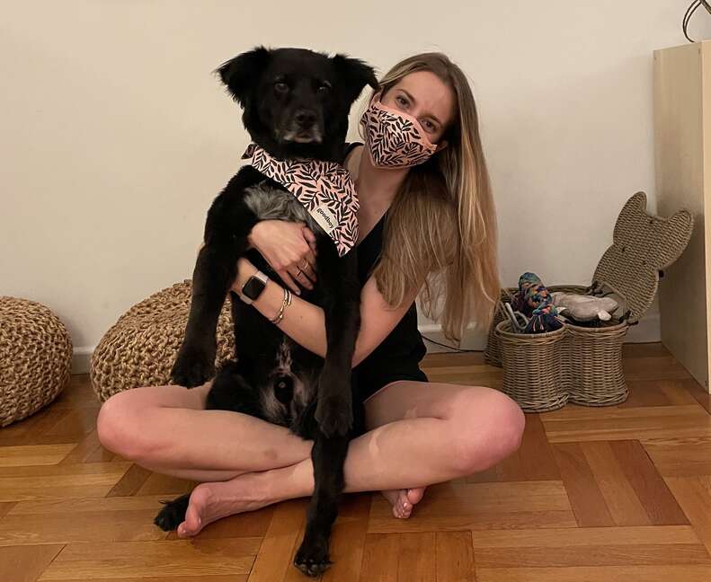 woman holding dog wearing matching Goodboy mask and bandana set