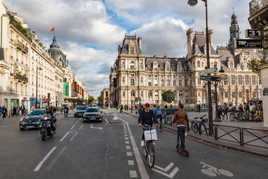 people riding bikes down Rue de Rivoli, Paris