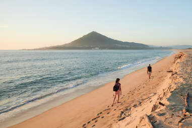 Moledo beach at sunset with Insua Fort in the background