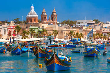 boats in the bay in Marsaxlokk fishing village, Malta