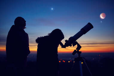people observing stars, planets, Moon and night sky with astronomical telescope