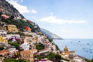 a view of the town and boats in positano, italy
