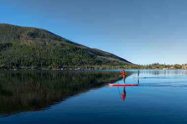 two paddleboarders on a lake