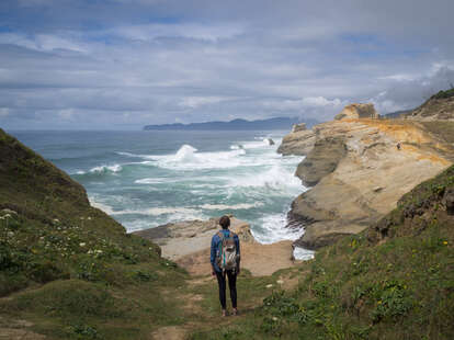 person standing in front of a stormy bay in Oregon