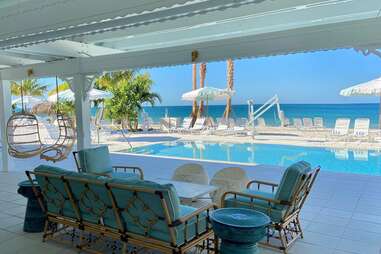 a pool club that fronts a white sand beach