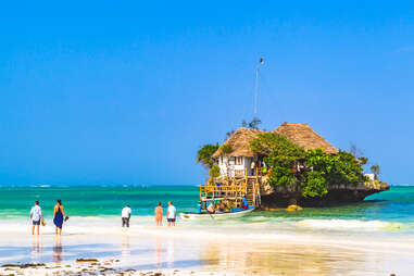 people waiting for boat to famous restaurant on a rock in Zanzibar