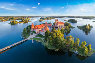 a large castle on an island in a lake