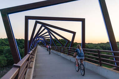 cyclists on high trestle trail bridge 