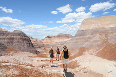 people walking through a deserted landscape