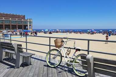 a bike parked in front of a busy beach
