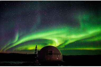An Alaskan igloo with a clear roof perfect for viewing the Aurora Borealis