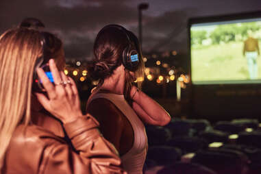 two women with headphones