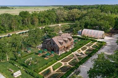 a farm in the middle of a garden on a stretch of land near the beach