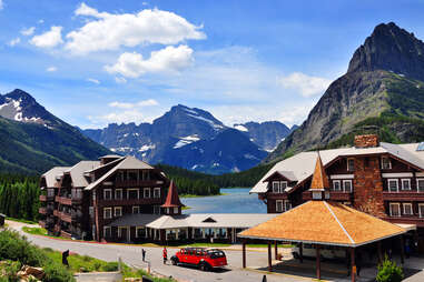 a lodge hotel near a lake surrounded by mountains