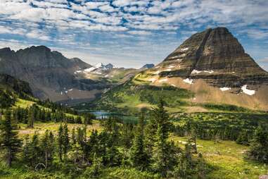 a mountain surrounded by lakes and trees