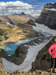 woman overlooking a glacial lake and mountains