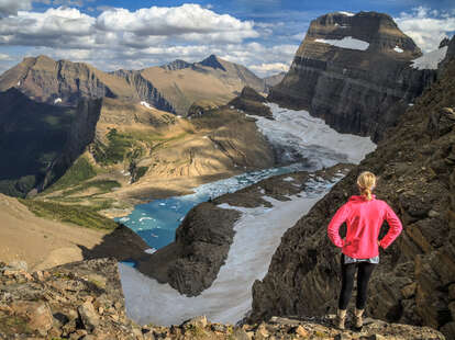 woman overlooking a glacial lake and mountains