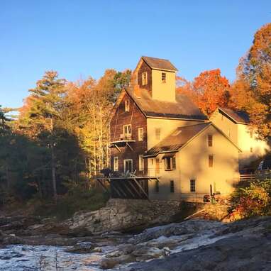 A historic grist mill perched atop Mill River waterfalls