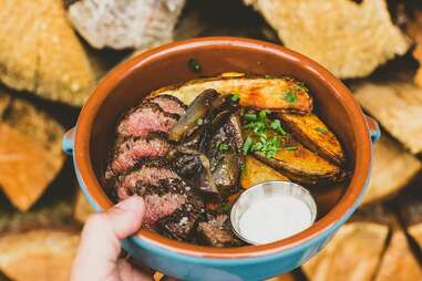 a bowl filled with steak and thick-cut fries