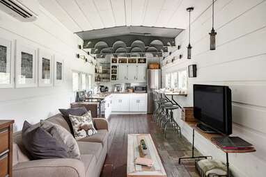 A converted WWII train car surrounded by nature