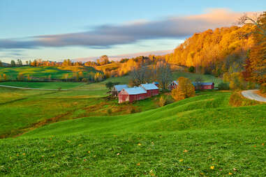 a rustic barn on rolling green hills