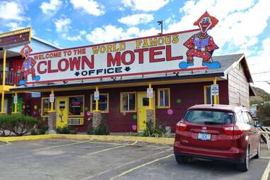 an unusual clown motel beneath a blue sky