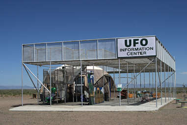 a large metal structure with the sign "ufo information center"