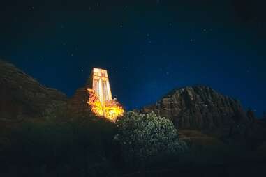 an unusually-shaped chapel in a desert mountain at night