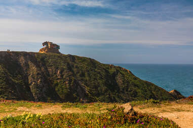 an abandoned bunker on a hill near the ocean