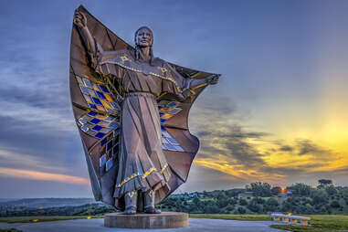 a giant steel statue of a native american woman