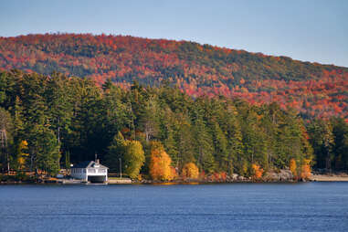 A boat house among fall foliage on Schroon Lake